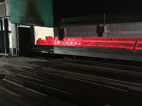 Positive heat treatment of pipe fittings and steel pipes